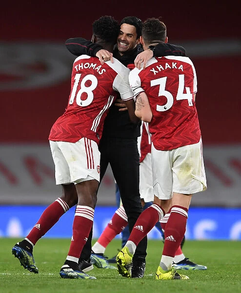 Arsenal's Mikel Arteta Celebrates with Partey and Xhaka after Arsenal vs. Tottenham Premier League Match