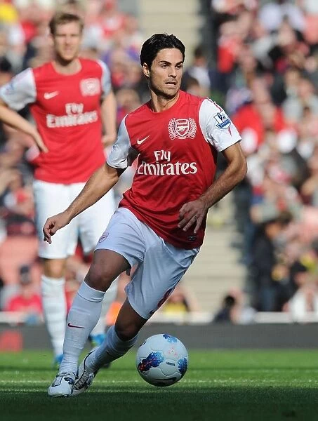 Arsenal's Mikel Arteta Leads the Way: 3-1 Victory Over Stoke City in the Premier League (2011-2012)
