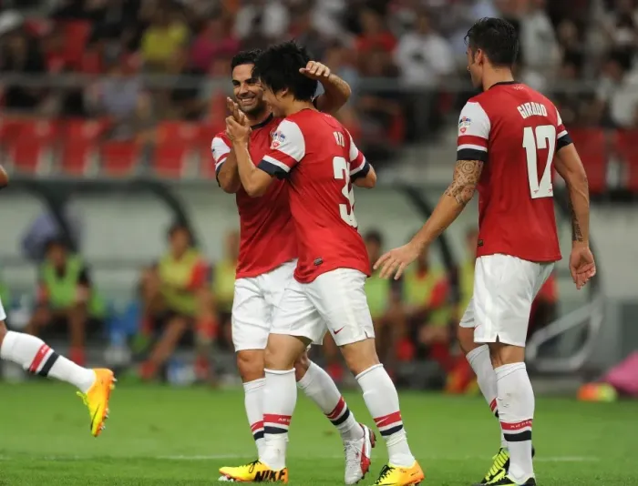 Framed Print : Arsenal's Miyaichi, Arteta, and Giroud Celebrate Goals Against Nagoya Grampus in 2013