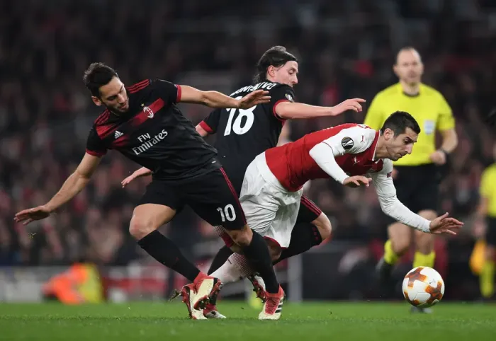Framed Print : Arsenal's Mkhitaryan Clashes with Calhanoglu and Montolivo in Europa League Showdown