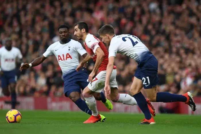 Framed Print : Arsenal's Mkhitaryan Clashes with Tottenham's Aurier and Foyth in Premier League Showdown