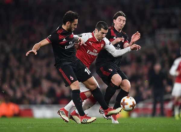 Arsenal's Mkhitaryan Faces Off Against Calhanoglu and Montolivo in Intense Europa League Clash