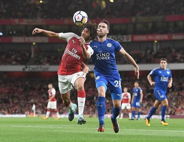 Arsenal's Mohamed Elneny Clashes with Leicester's Christian Fuchs in Premier League Showdown