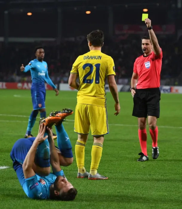Framed Print : Arsenal's Mustafi Fouls BATE's Dragun: Referees Yellow Card in Europa League Clash Framed Print : Arsenal's Mustafi Fouls BATE's Dragun: Referees Yellow Card in Europa League Clash