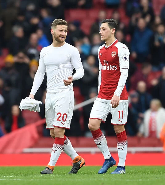 Arsenal's Mustafi and Ozil: Savoring Victory over Stoke City in the Premier League