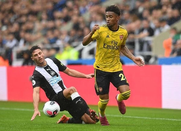 Arsenal's Nelson Clashes with Schar in Premier League Battle: Arsenal vs Newcastle United, 2019-20