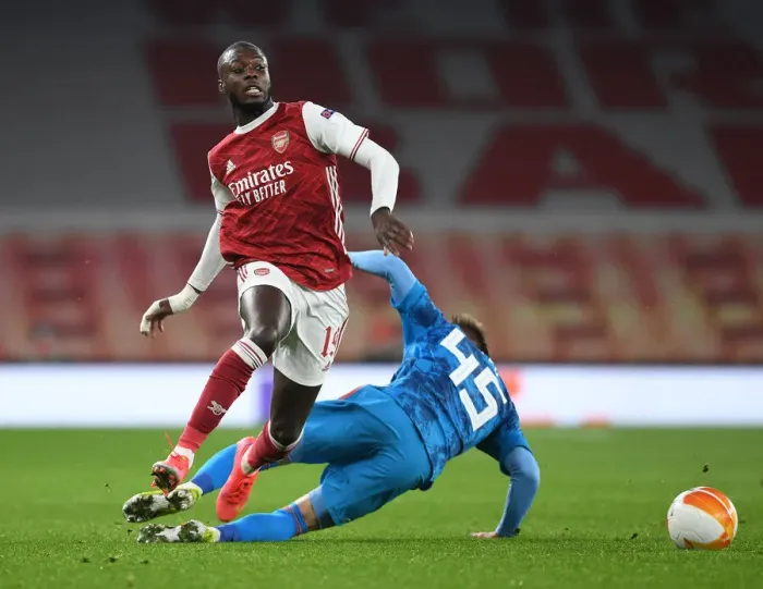 Framed Print : Arsenal's Nicolas Pepe Breaks Past Olympiacos Defender in Empty Emirates Stadium - Arsenal v Olympiacos, UEFA Europa League 2020-21