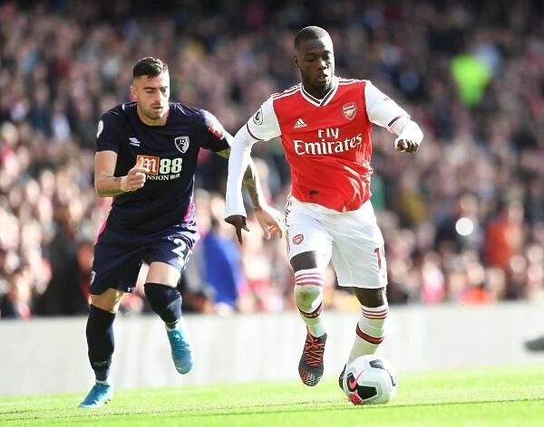 Arsenal's Nicolas Pepe Clashes with Bournemouth's Diego Rico in Premier League Showdown