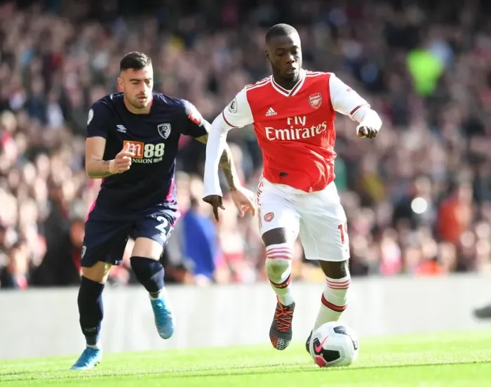 Framed Print : Arsenal's Nicolas Pepe Clashes with Bournemouth's Diego Rico in Premier League Showdown