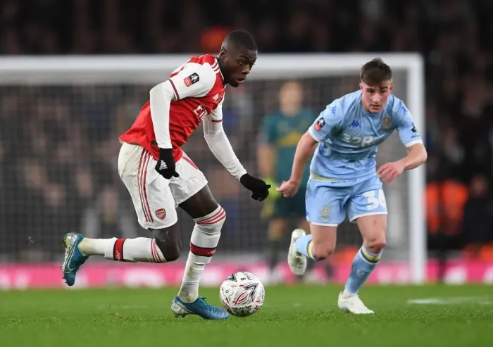 Framed Print : Arsenal's Nicolas Pepe Clashes with Leeds United's Robbie Gotts in FA Cup Third Round