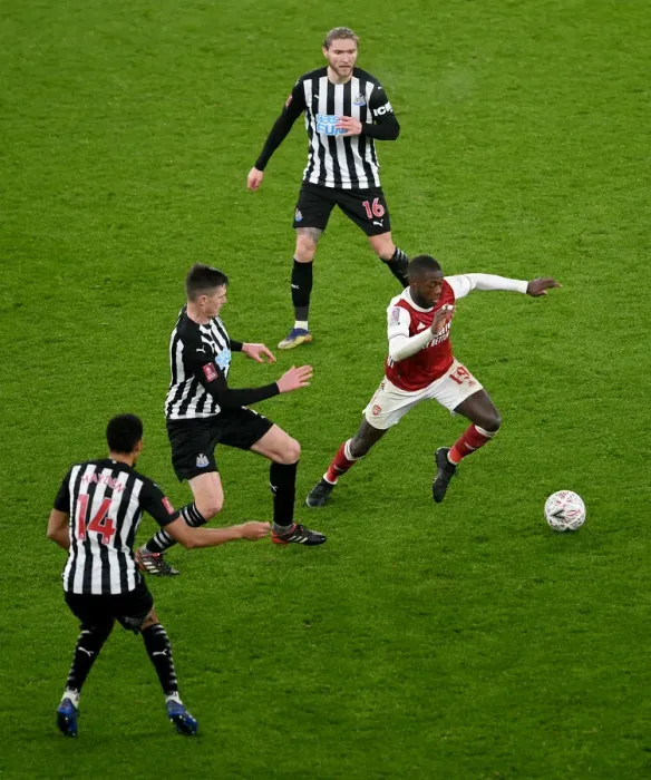Framed Print : Arsenal's Nicolas Pepe Clashes with Newcastle's Ciaran Clark in FA Cup Third Round