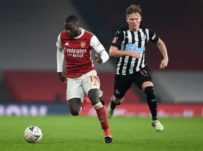 Framed Print : Arsenal's Nicolas Pepe Clashes with Newcastle's Matt Ritchie in FA Cup Third Round Framed Print : Arsenal's Nicolas Pepe Clashes with Newcastle's Matt Ritchie in FA Cup Third Round