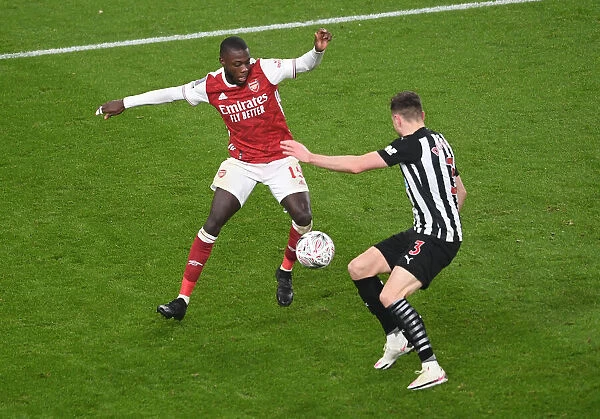 Arsenal's Nicolas Pepe Clashes with Newcastle's Paul Dummett in FA Cup Third Round