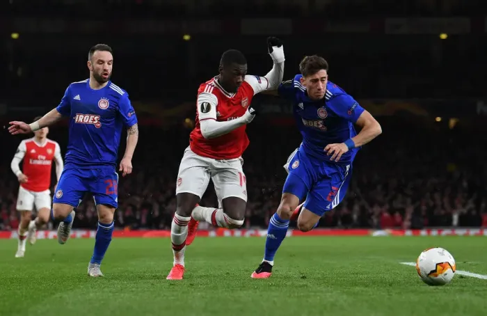 Framed Print : Arsenal's Nicolas Pepe Clashes with Olympiacos Kostas Tsimikas in Europa League Showdown