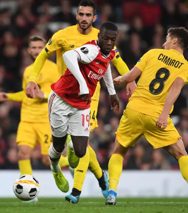 Framed Print : Arsenal's Nicolas Pepe Clashes with Standard Liege's Gojko Cimirot in Europa League Match