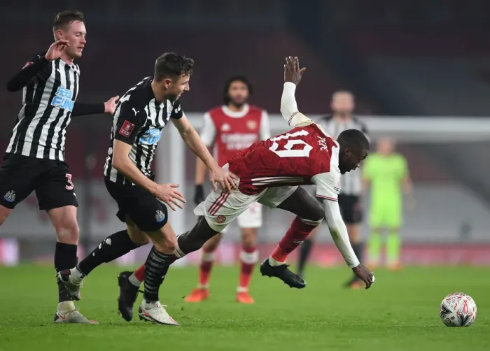 Framed Print : Arsenal's Nicolas Pepe Faces Off Against Newcastle's Paul Dummett in FA Cup Clash