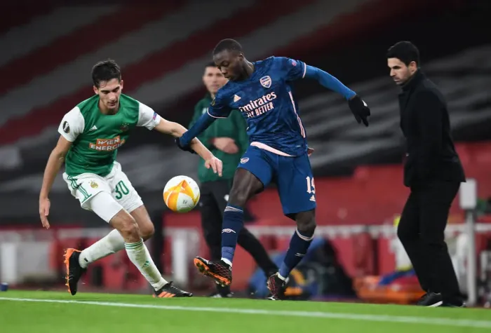 Framed Print : Arsenal's Nicolas Pepe Faces Off Against Rapid Wien's Leo Greiml in Empty Emirates Stadium - UEFA Europa League 2020-21