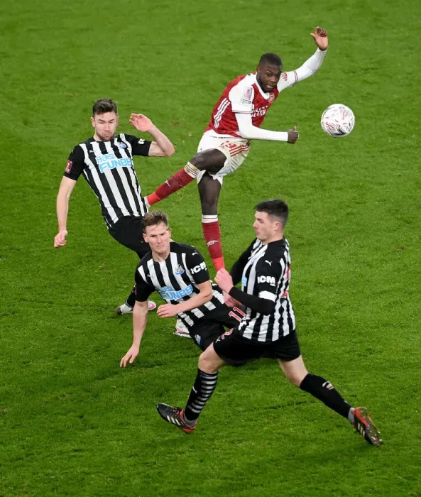 Framed Print : Arsenal's Nicolas Pepe Faces Pressure from Newcastle's Defense in FA Cup Clash