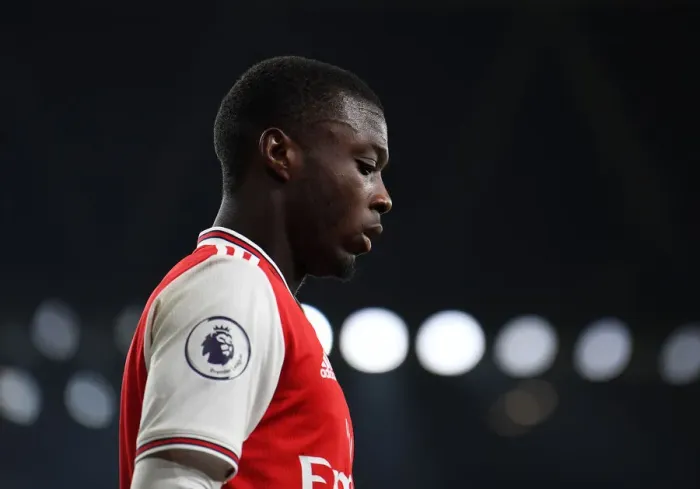 Framed Print : Arsenal's Nicolas Pepe Goes Head-to-Head with Manchester United in Premier League Clash