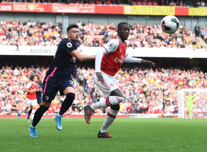 Framed Print : Arsenal's Nicolas Pepe Outmaneuvers Bournemouth's Diego Rico in Premier League Clash