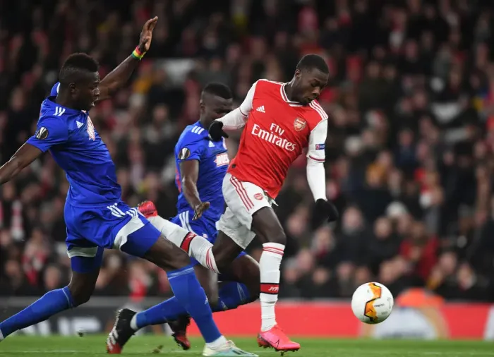 Framed Print : Arsenal's Nicolas Pepe Outmaneuvers Olympiacos Pape Abou Cisse in Europa League Clash Framed Print : Arsenal's Nicolas Pepe Outmaneuvers Olympiacos Pape Abou Cisse in Europa League Clash