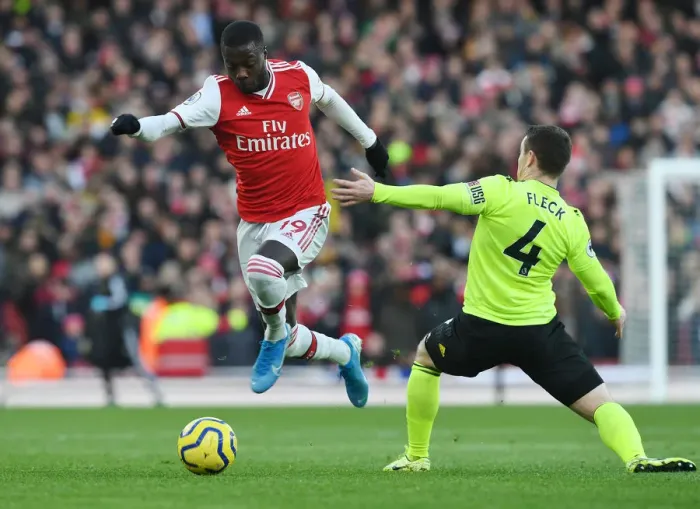 Framed Print : Arsenal's Nicolas Pepe Outmaneuvers Sheffield United's John Fleck during the Premier League Clash Framed Print : Arsenal's Nicolas Pepe Outmaneuvers Sheffield United's John Fleck during the Premier League Clash