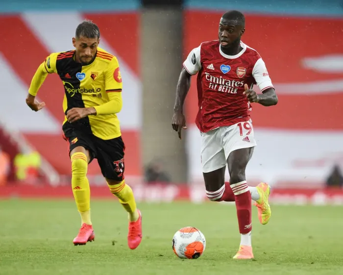 Framed Print : Arsenal's Nicolas Pepe Outmaneuvers Watford's Roberto Pereyra in Premier League Clash Framed Print : Arsenal's Nicolas Pepe Outmaneuvers Watford's Roberto Pereyra in Premier League Clash