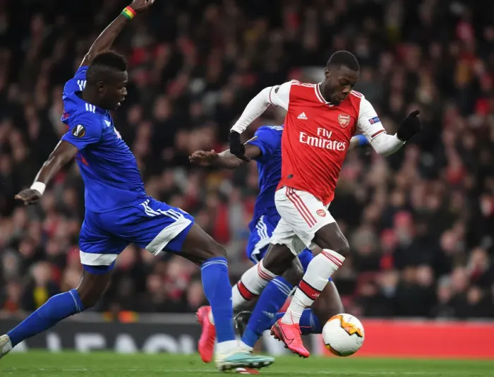 Framed Print : Arsenal's Nicolas Pepe Outsmarts Pape Abou Cisse: Thrilling Europa League Clash at Emirates Stadium