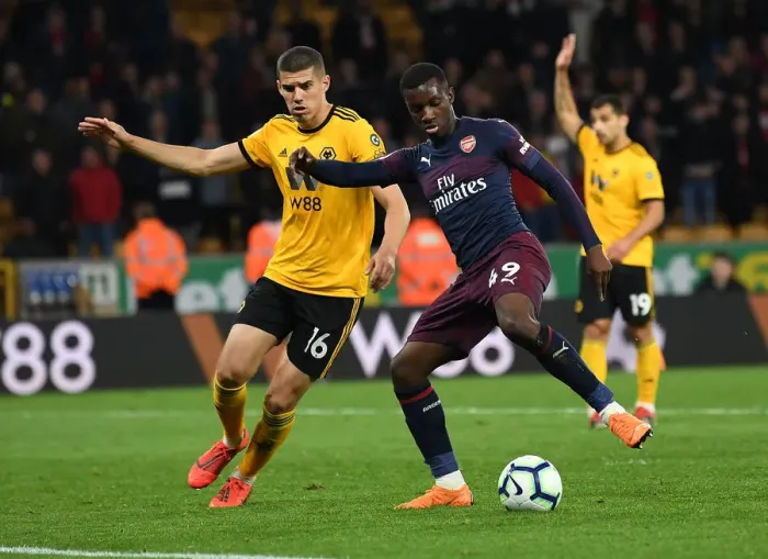 Framed Print : Arsenal's Nketiah Faces Off Against Wolverhampton's Coady in Premier League Clash