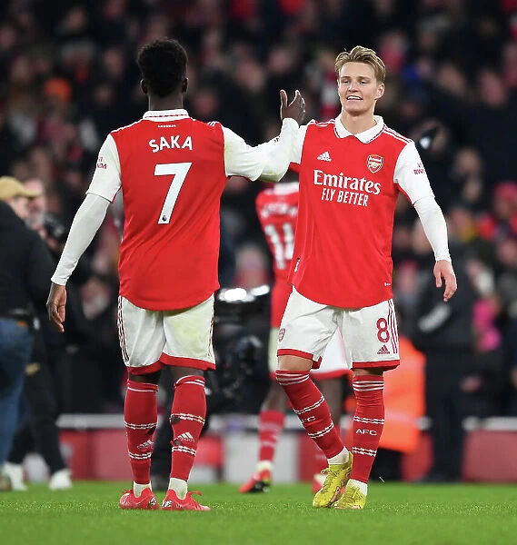 Arsenal's Odegaard and Saka Celebrate Victory Over Manchester United in 2022-23 Premier League