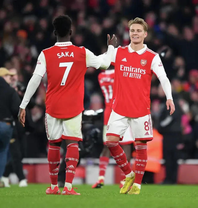 Framed Print : Arsenal's Odegaard and Saka Celebrate Victory Over Manchester United in 2022-23 Premier League