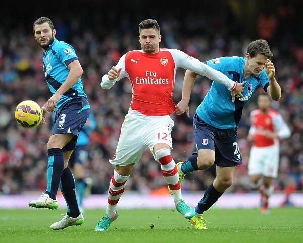 Arsenal's Olivier Giroud Battles Past Stoke's Erik Pieters and Philipp Wollscheid