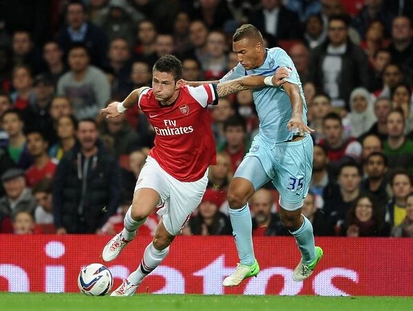 Arsenal's Olivier Giroud Clashes with Coventry's Reece Brown in Capital One Cup Showdown