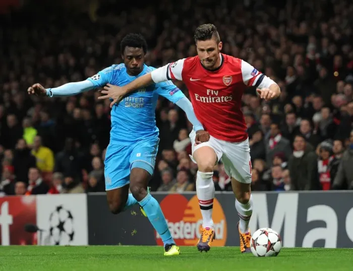 Framed Print : Arsenal's Olivier Giroud Clashes with Marseille's Nicolas N'Koulou in Champions League Showdown