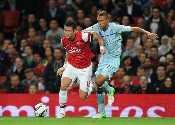 Arsenal's Olivier Giroud Faces Off Against Coventry's Reece Brown in Capital One Cup Clash