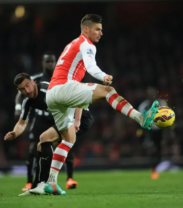 Framed Print : Arsenal's Olivier Giroud Faces Off Against Newcastle's Paul Dummett in Intense Premier League Clash Framed Print : Arsenal's Olivier Giroud Faces Off Against Newcastle's Paul Dummett in Intense Premier League Clash