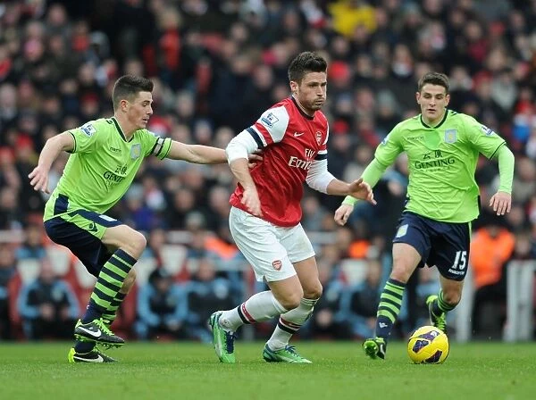 Arsenal's Olivier Giroud Fends Off Aston Villa's Defenders During Premier League Clash