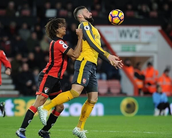 Arsenal's Olivier Giroud Fends Off Bournemouth's Nathan Ake in Premier League Clash