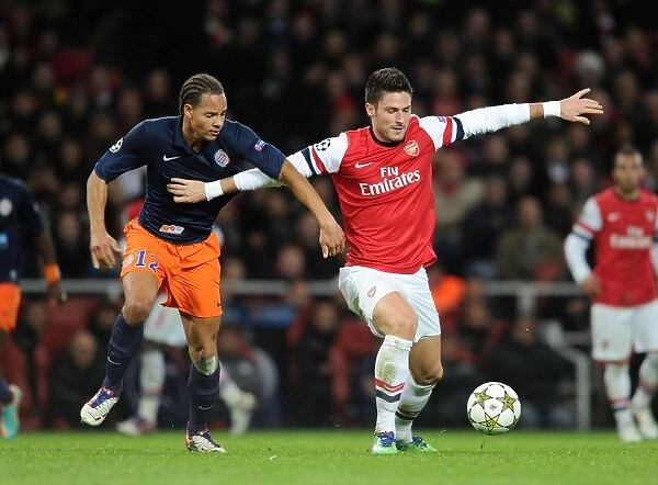 Arsenal's Olivier Giroud Fends Off Montpellier's Daniel Congre during Champions League Clash