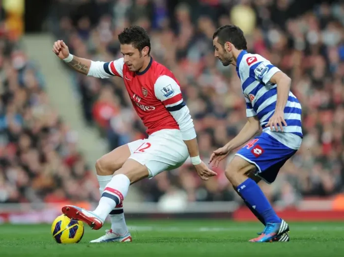 Framed Print : Arsenal's Olivier Giroud Fends Off QPR's Esteban Granero During Premier League Clash (2012-13) Framed Print : Arsenal's Olivier Giroud Fends Off QPR's Esteban Granero During Premier League Clash (2012-13)