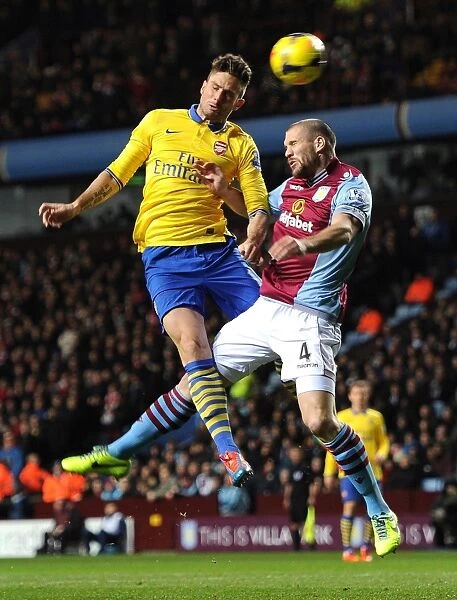 Arsenal's Olivier Giroud Heads Past Aston Villa's Ronald Vlaar in Premier League Clash