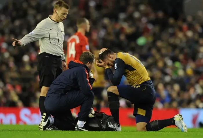 Framed Print : Arsenal's Olivier Giroud Receives Medical Attention on the Field during Liverpool vs Arsenal, Premier League 2015-16