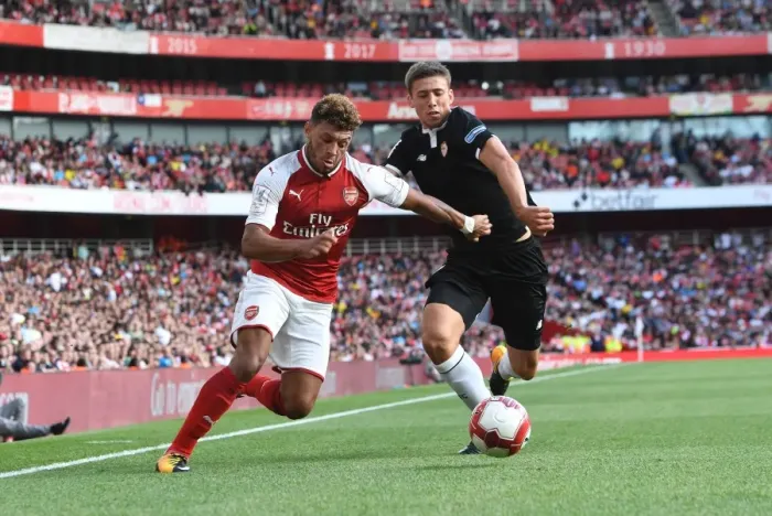 Framed Print : Arsenal's Oxlade-Chamberlain Clashes with Sevilla's Corchia in Emirates Cup Battle