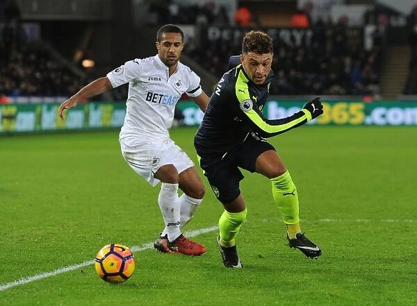Arsenal's Oxlade-Chamberlain Faces Off Against Swansea's Routledge in Premier League Clash