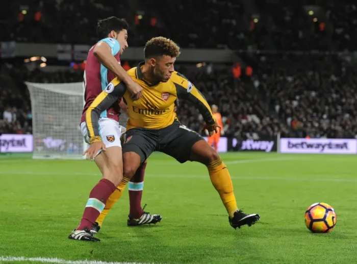 Framed Print : Arsenal's Oxlade-Chamberlain Fends Off West Ham's Arbeloa in Premier League Clash Framed Print : Arsenal's Oxlade-Chamberlain Fends Off West Ham's Arbeloa in Premier League Clash