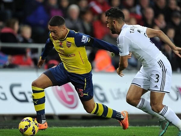 Arsenal's Oxlade-Chamberlain Outmaneuvers Swansea's Taylor in Premier League Clash (Swansea v Arsenal 2014-15)