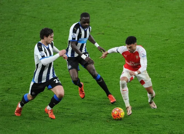 Framed Print : Arsenal's Oxlade-Chamberlain Stands Firm Against Newcastle's Janmaat and Sissoko