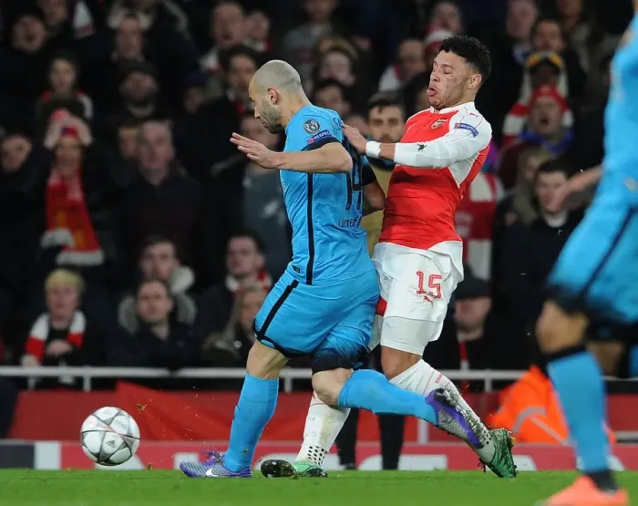 Framed Print : Arsenal's Oxlade-Chamberlain Suffers Injury in Clash with Mascherano during Arsenal v Barcelona UCL Clash (2016)