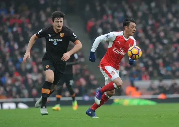 Framed Print : Arsenal's Ozil Clashes with Hull's Maguire in Premier League Showdown