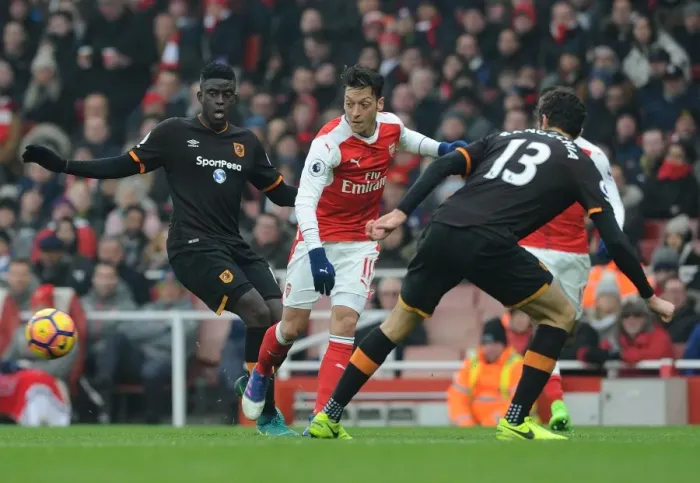 Framed Print : Arsenal's Ozil Evades Defenders in Intense Arsenal v Hull City Premier League Clash